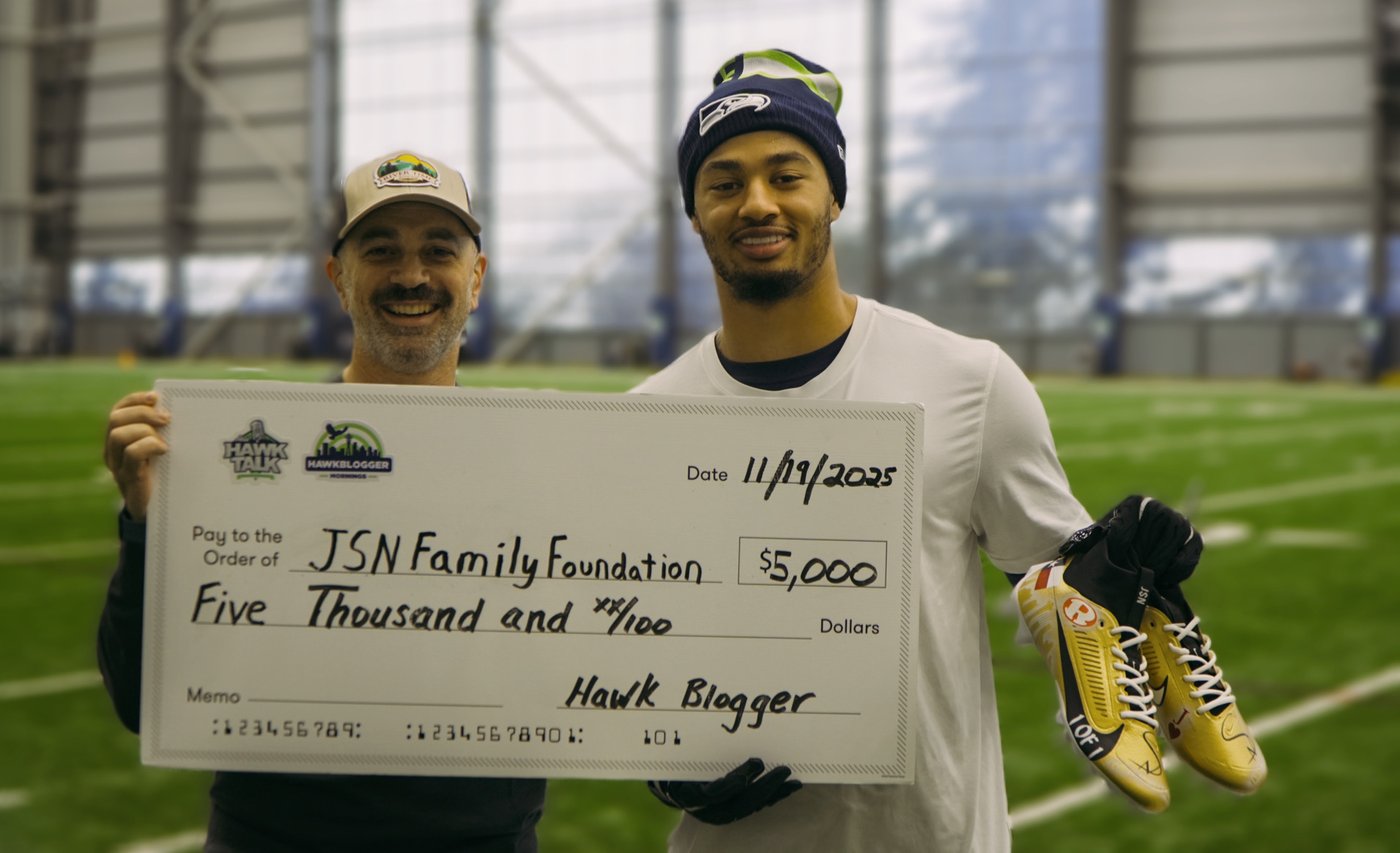 Brian and Jaxon Smith-Njigba presenting a $5,000 donation to the JSN Family Foundation